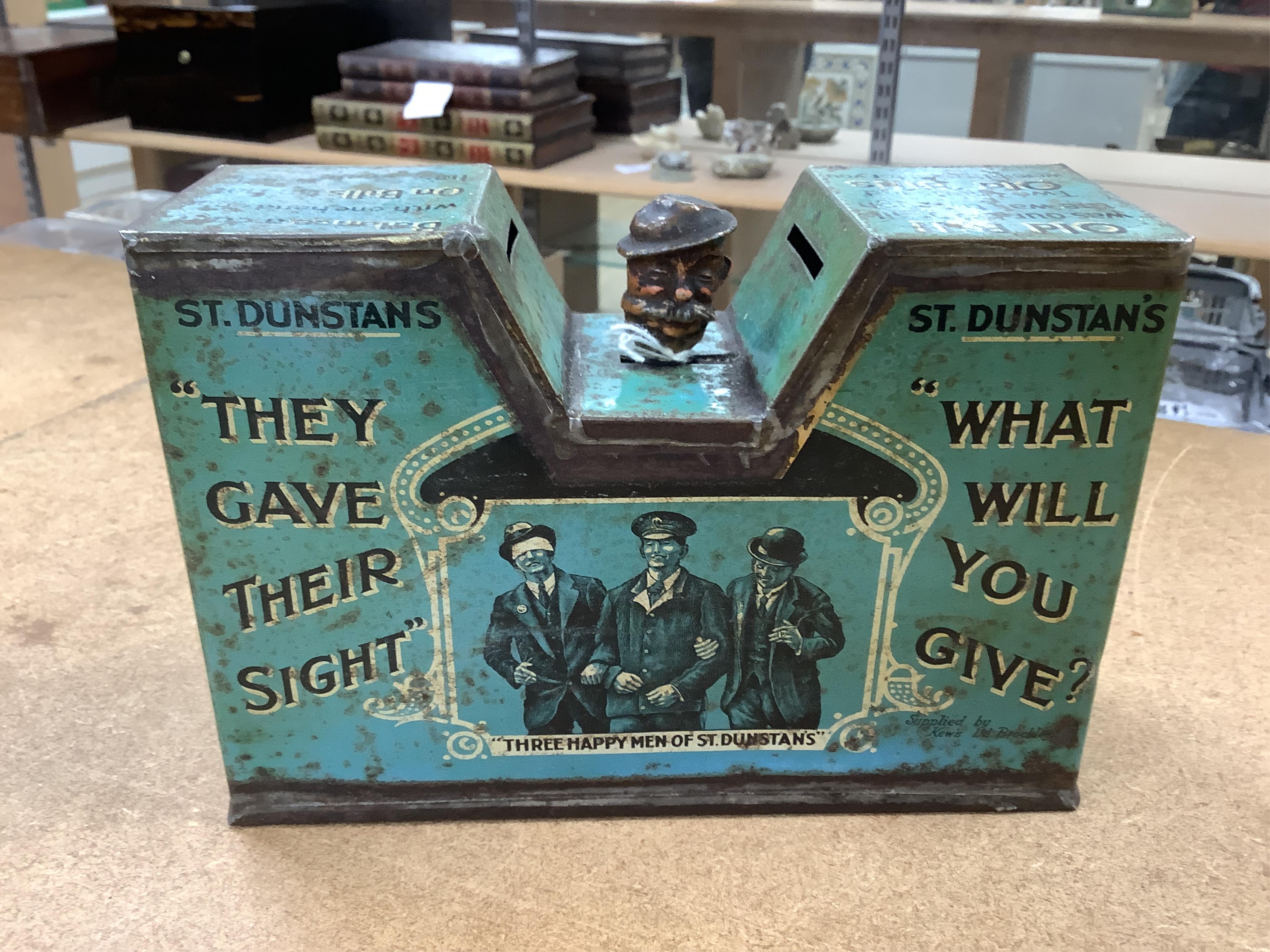 A quantity of various painted tin money boxes including Lucie Attwell Fairy House, The ‘Daily Mail’ copper bank, and four in the form of books, largest 20cm high. Condition - mostly fair